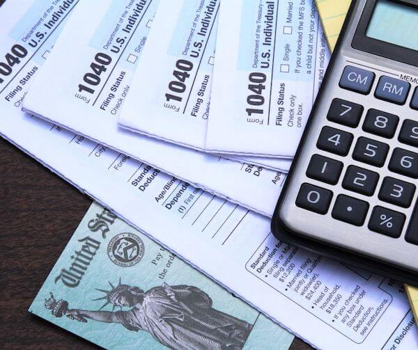 papers on a table and a calculator tax preparation